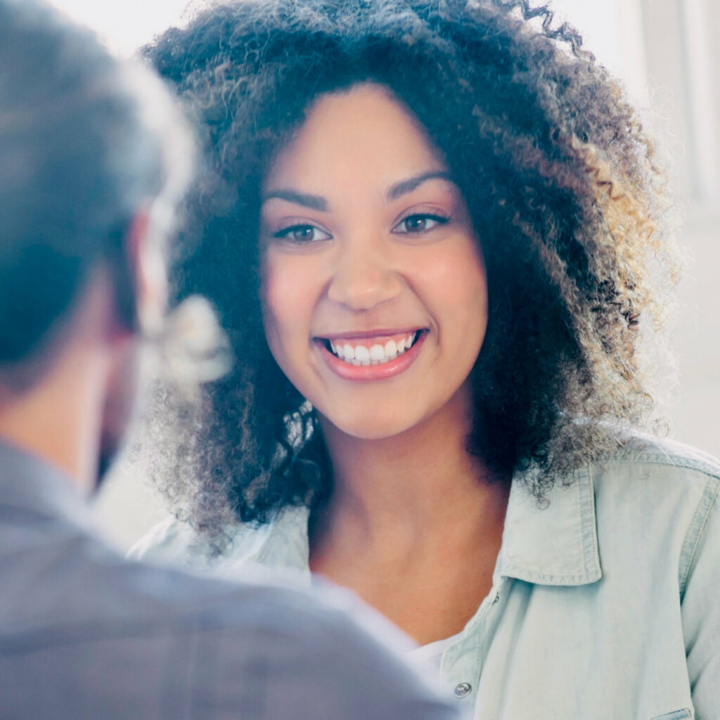 a woman smiling at a man.